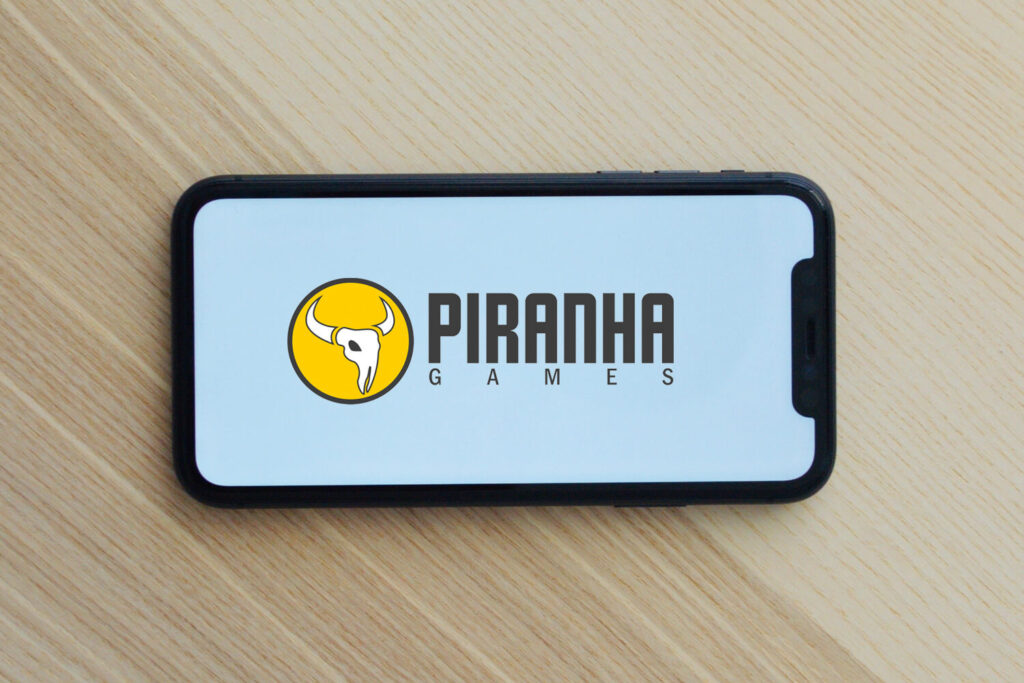 Piranha Games logo on a mobile phone