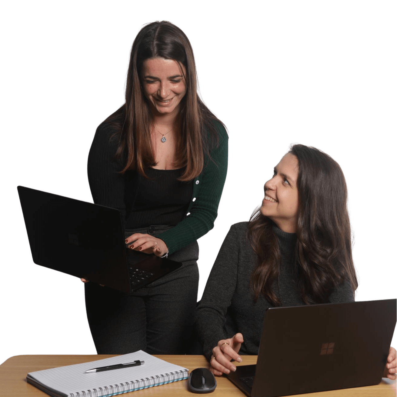 Two Global Lingo employees looking at a computer screen smiling
