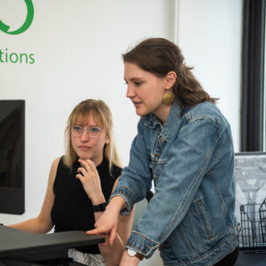 Two Global Lingo employees looking at a screen and working together