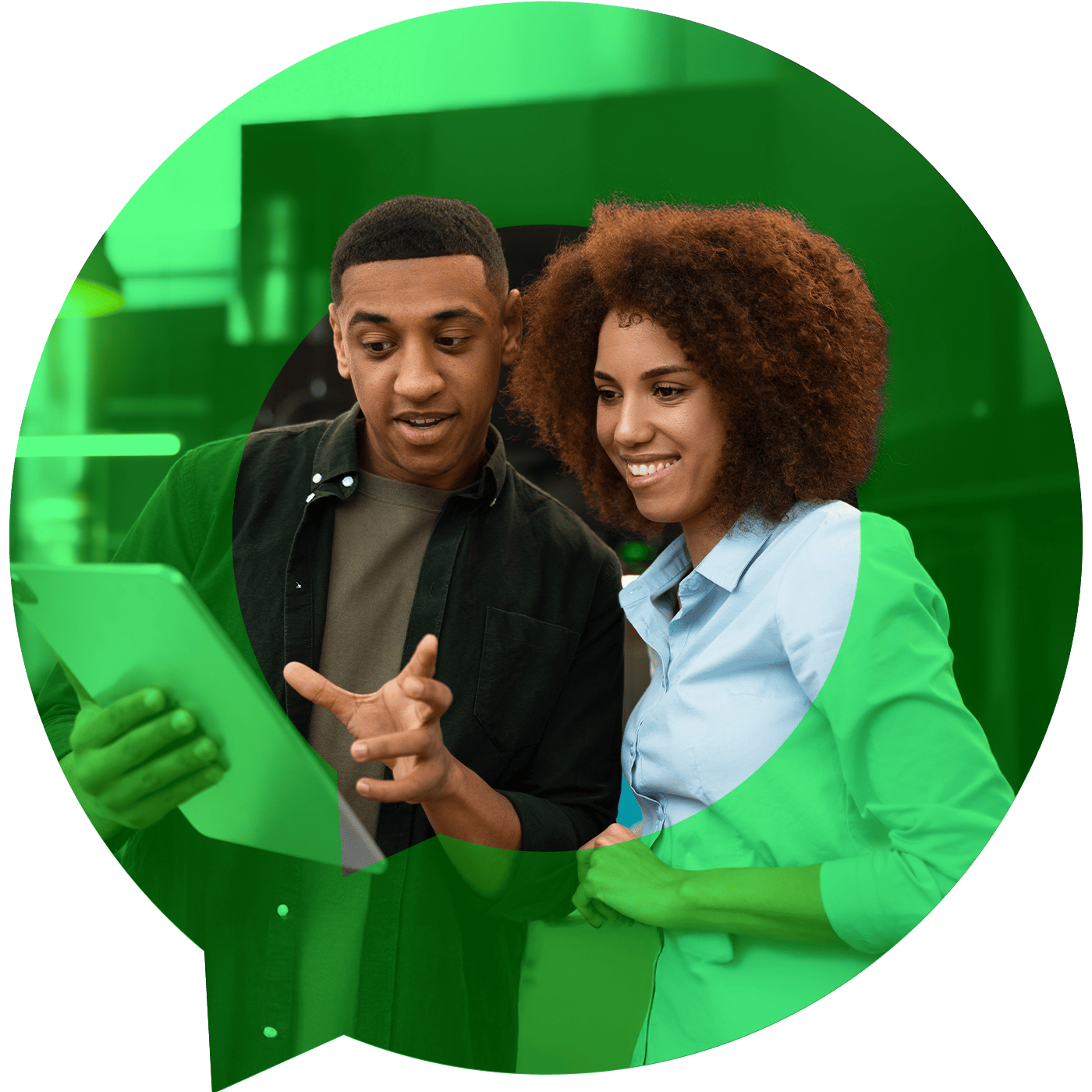 two employees smiling looking at an ipad with a green speech bubble surrounding them