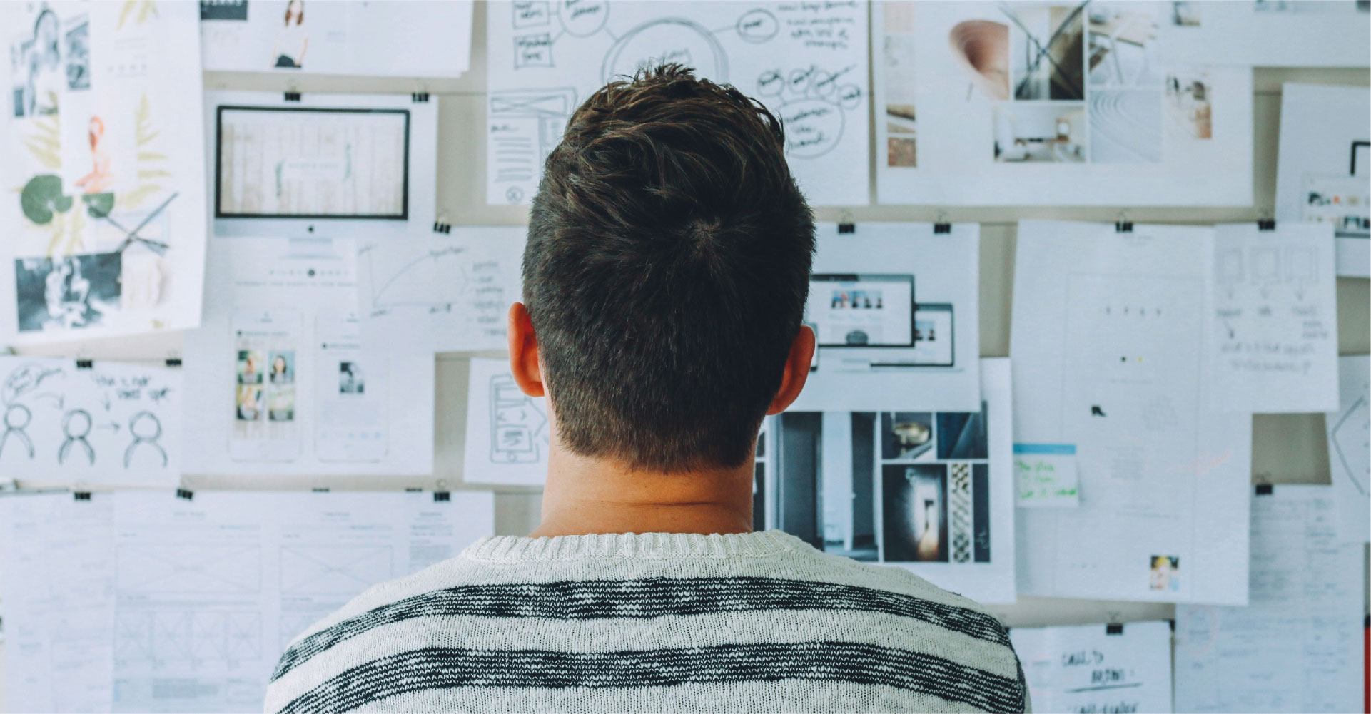 A researcher looking at evidence mounted on his wall