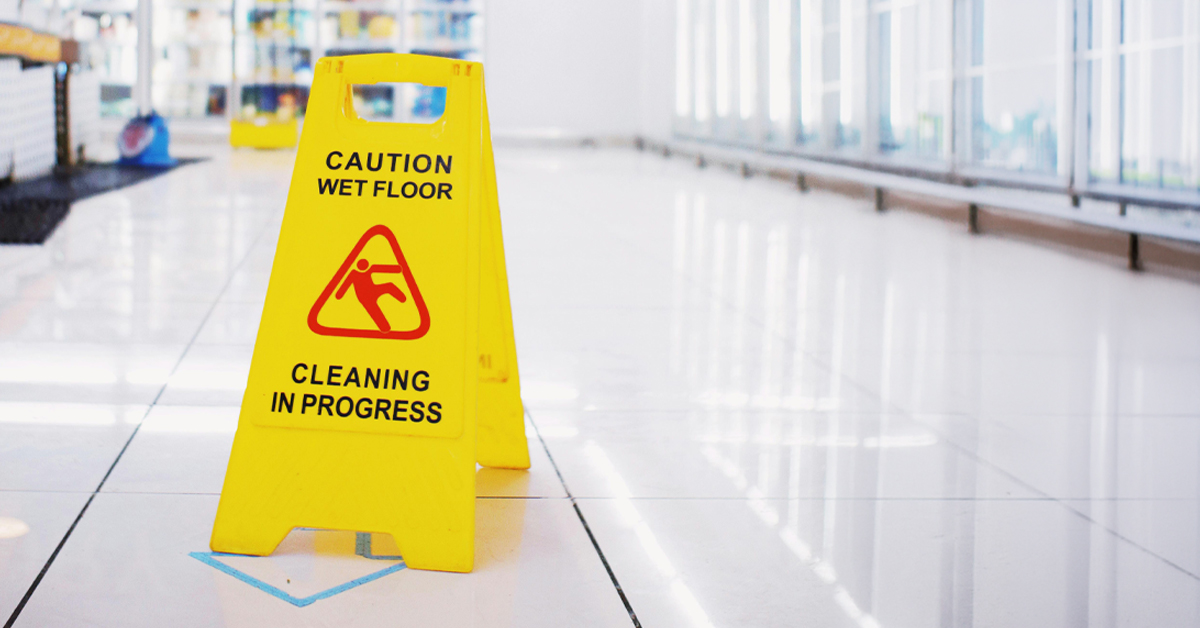 Caution wet floor sign in a retail walkway during cleaning