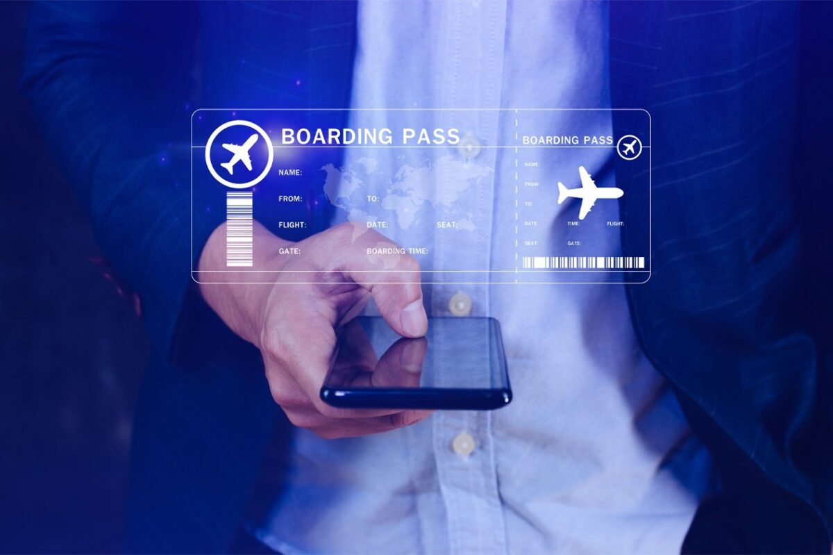 Hand holding a smartphone displaying a digital boarding pass, emphasizing the digital-first nature of modern travel demand trends.
