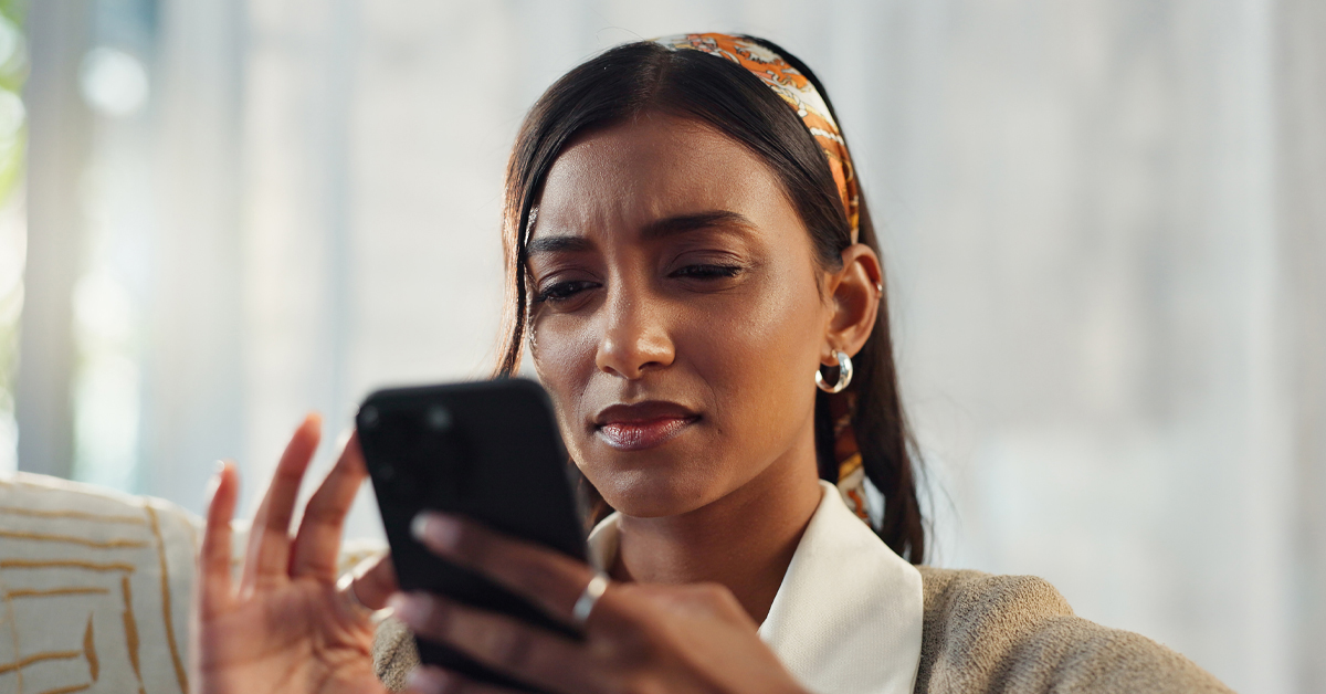 A close-up of a person looking intently at a smartphone screen, illustrating the technical quality assurance phase of global market research.