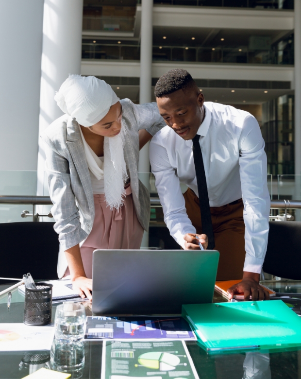 Colleagues in a modern workspace collaborating on a digital task, representing dedicated language expertise. Azeri Language Services