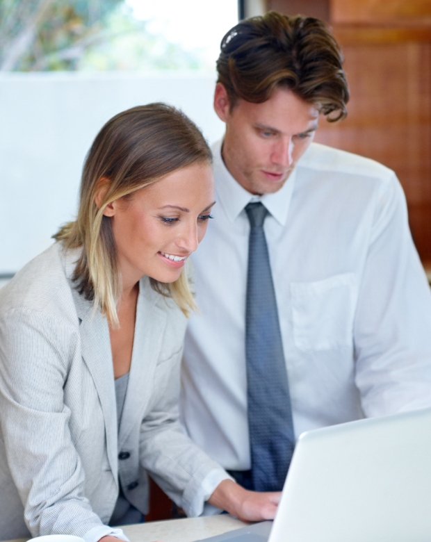 Corporate professionals reviewing project milestones on a tablet, symbolizing German localization services