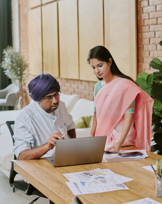 Business professionals discussing content on a computer, representing Marathi language services
