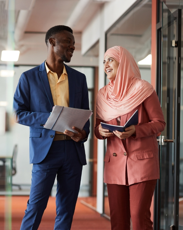 Focused colleagues sharing insights in a modern workspace, representing Pashto language solutions