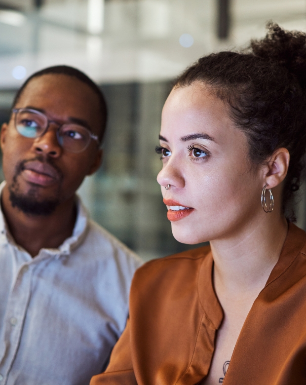 Close-up of two focused professionals looking at a screen, representing high-quality Croatian language interpretation