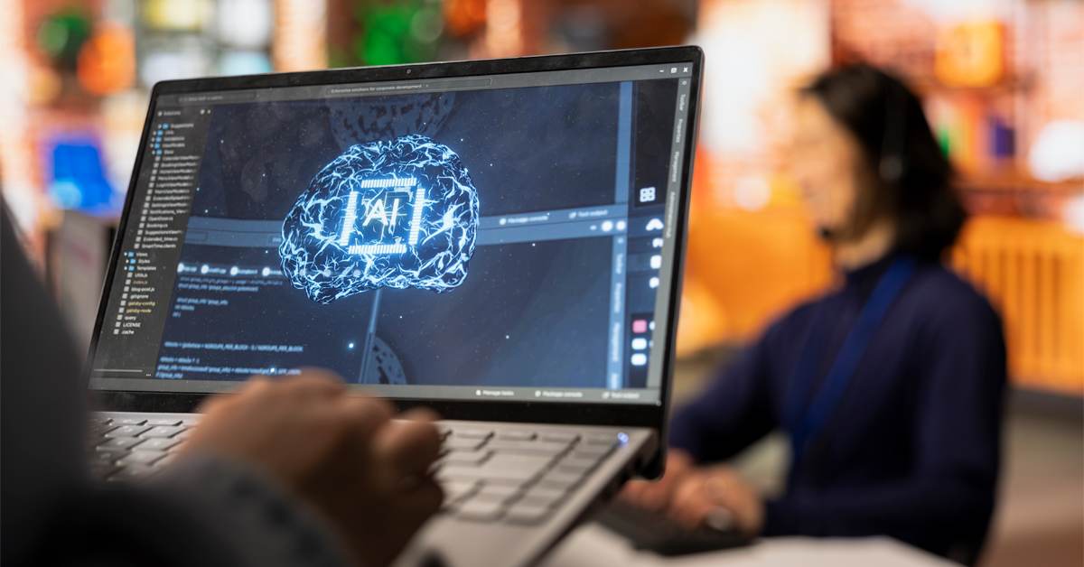 Person working on a laptop displaying an AI brain graphic, representing how artificial intelligence has matured in the market research industry