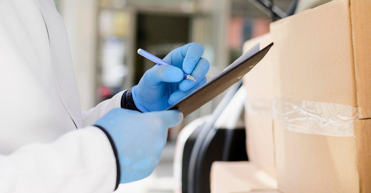 Person in gloves checking boxes on a clipboard, representing a localization workflow for food and beverage packaging content teams