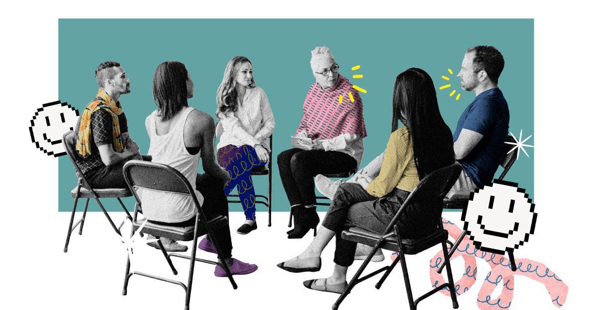 A focus group moderator taking notes while a group of participants sits in a circle of folding chairs