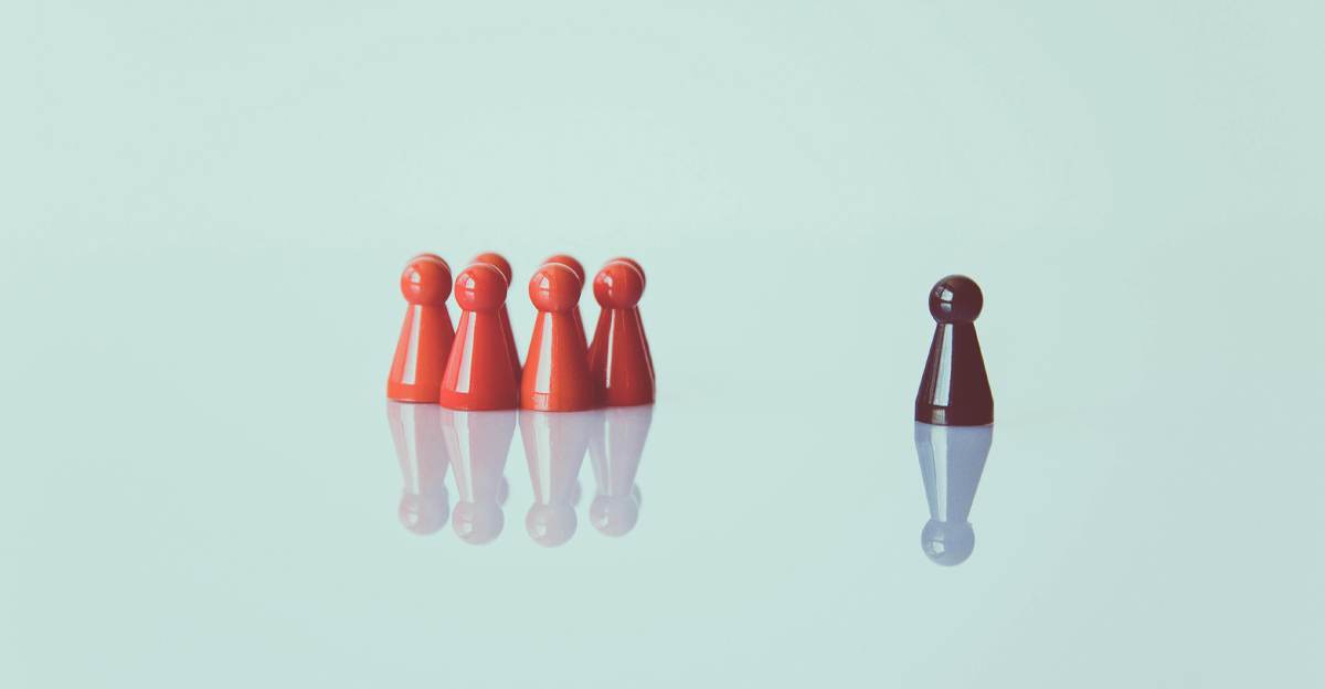 One dark figure standing apart from a group of red figures, representing a single translator working alone
