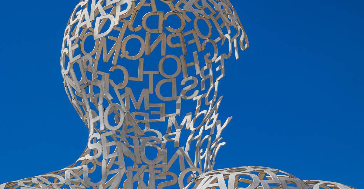 A sculpture of a human head formed from jumbled letters, symbolizing the question "what is translation bias?"